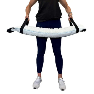 Person holding a recycled fire hose battle bag for workouts.