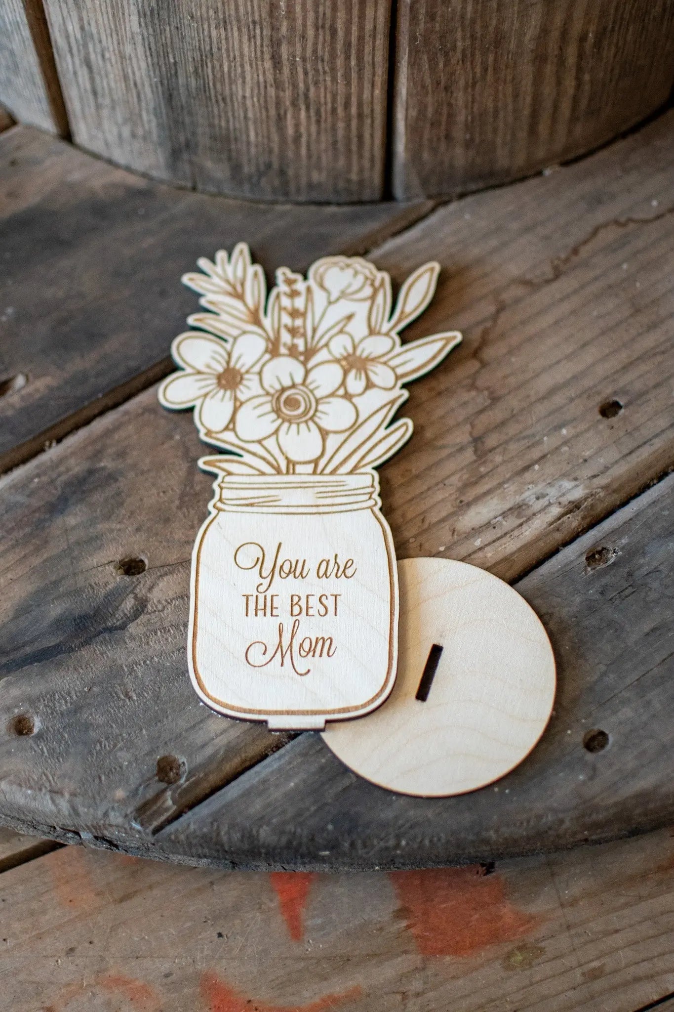 Wooden vase with flowers and "You are the best Mom" text on a wooden surface.