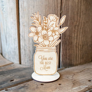 Wooden mason jar floral decoration that says "You are the best Mom".
