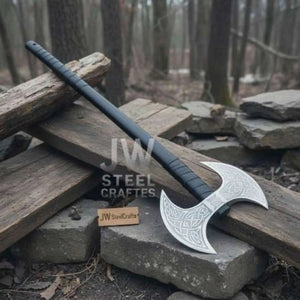 Damascus steel axe head with premium handle on rustic wood surface