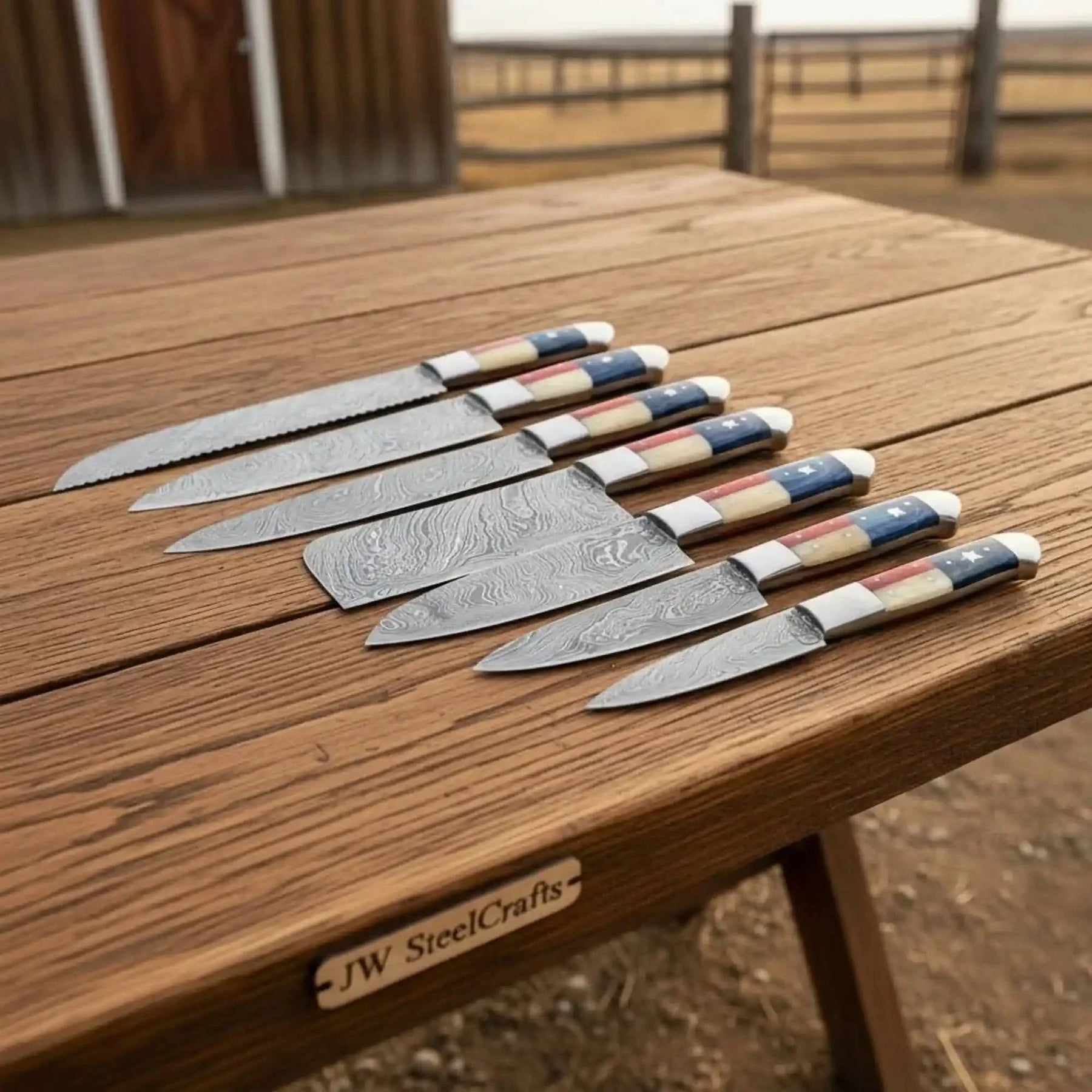 Handmade damascus steel knife with premium handle on dark surface