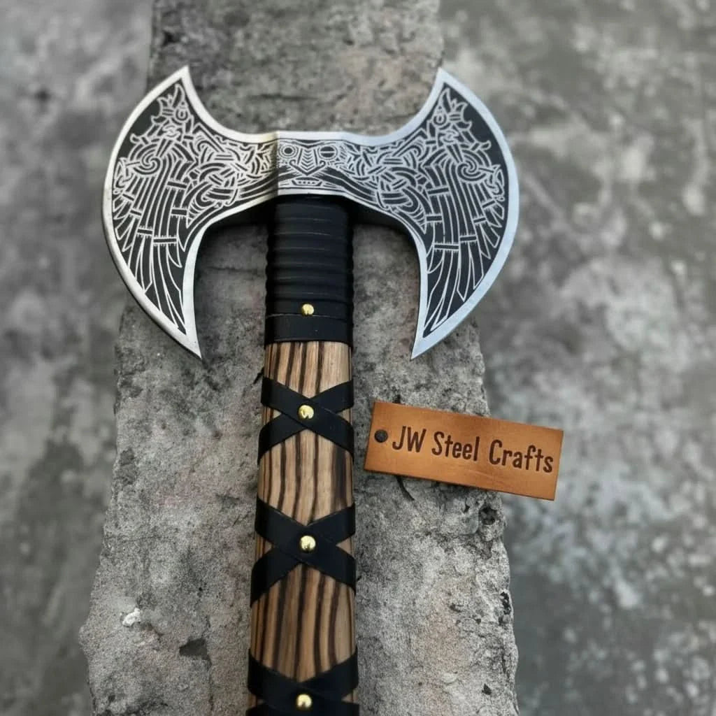 Damascus steel axe head with leather handle on rustic wood surface