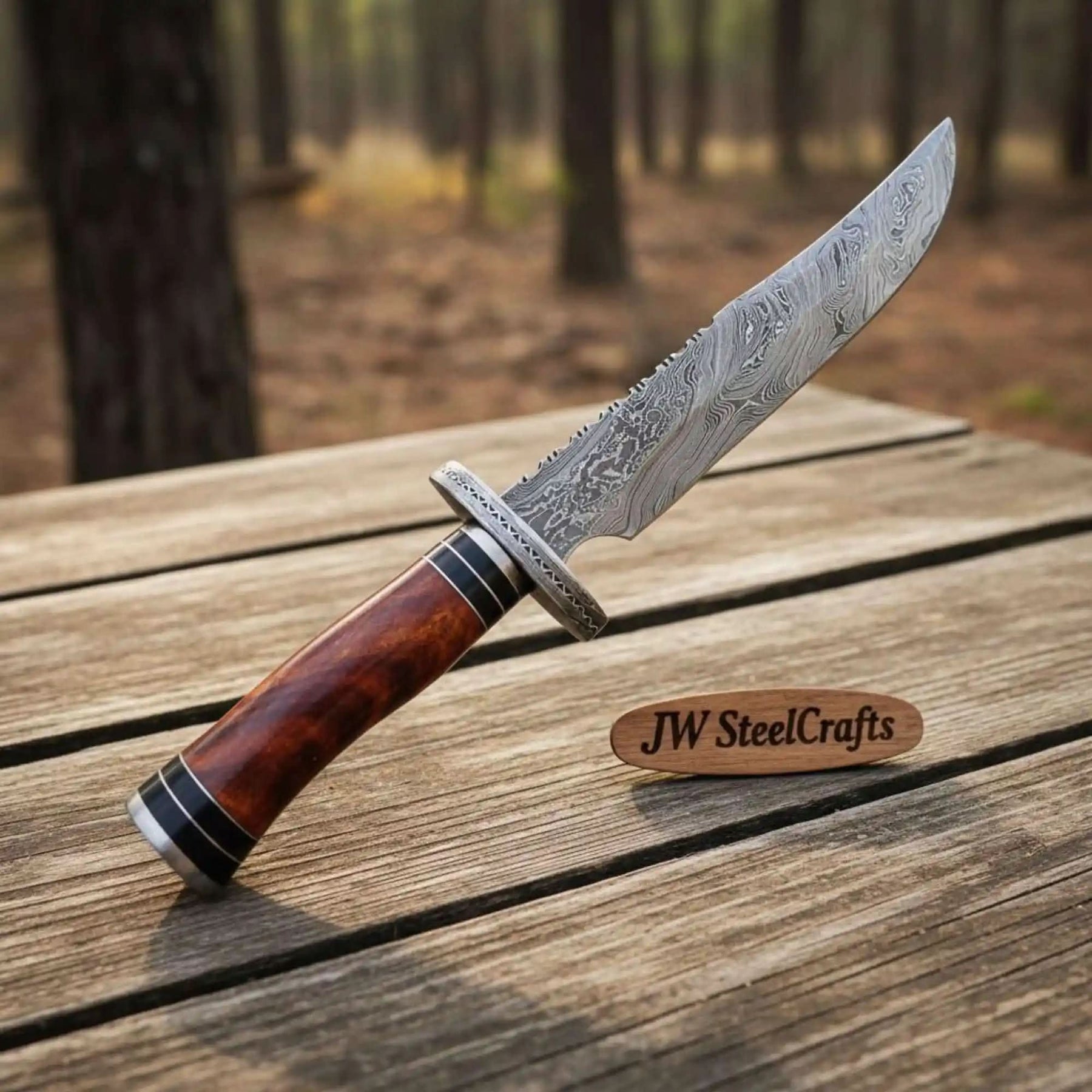 Handmade damascus steel knife with premium handle on dark surface