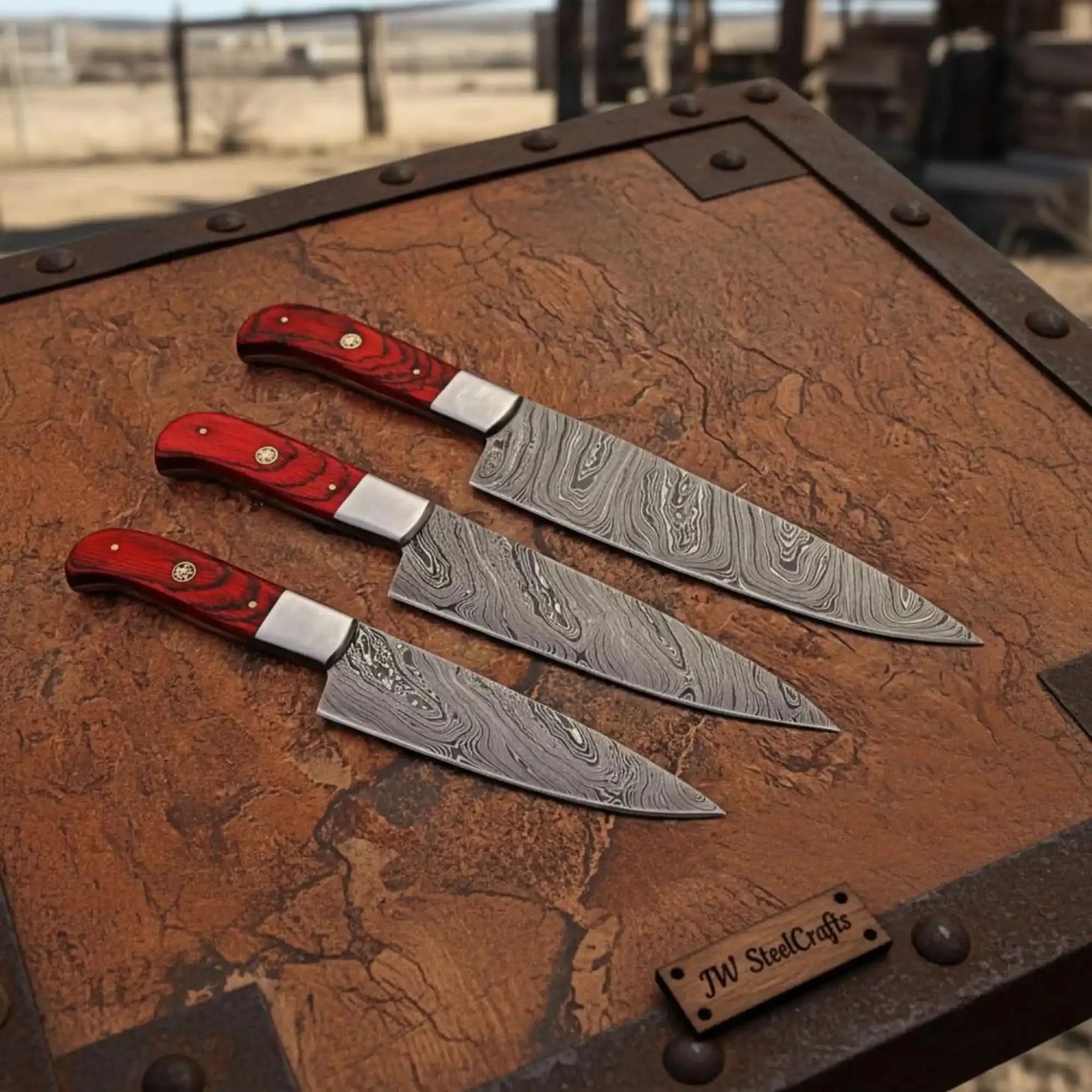 Handmade damascus steel knife with wood handle on dark surface