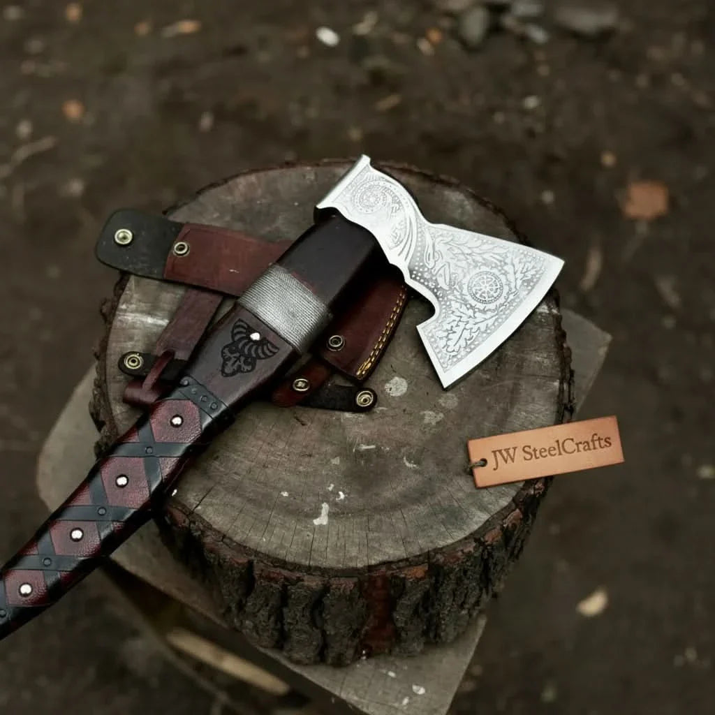 Damascus steel axe head with leather handle on rustic wood surface