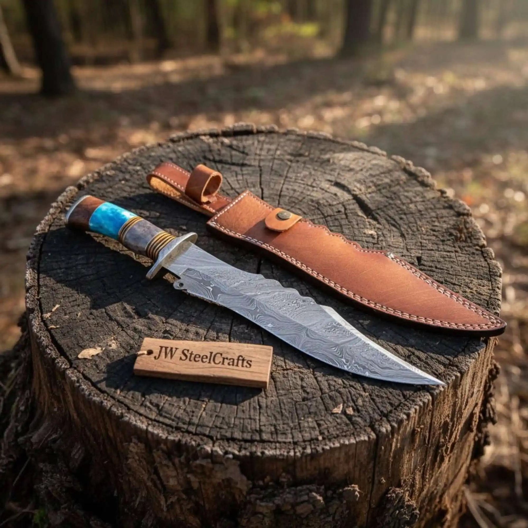 Handmade damascus steel knife with wood handle on dark surface
