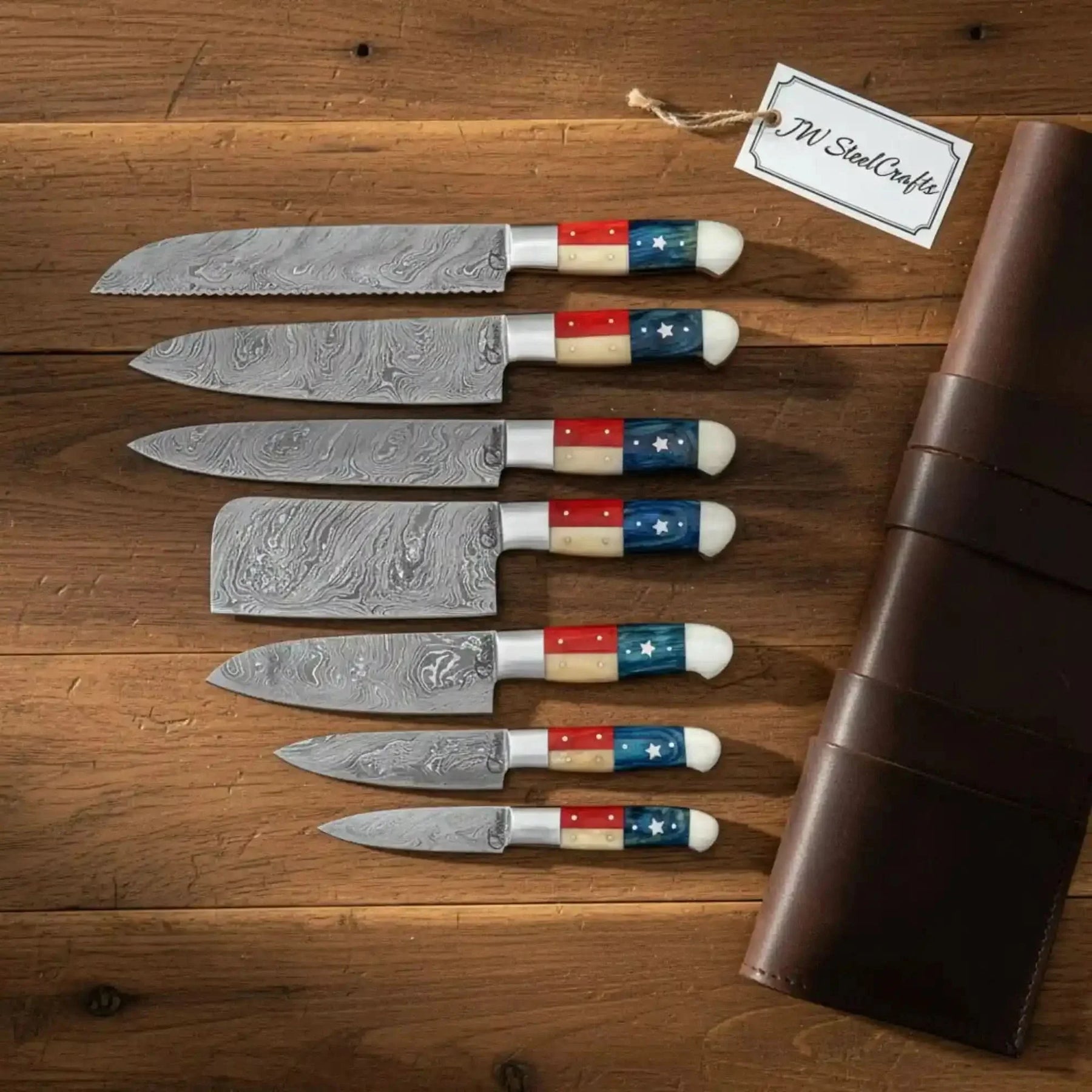 Handmade damascus steel knife with wood handle on dark surface