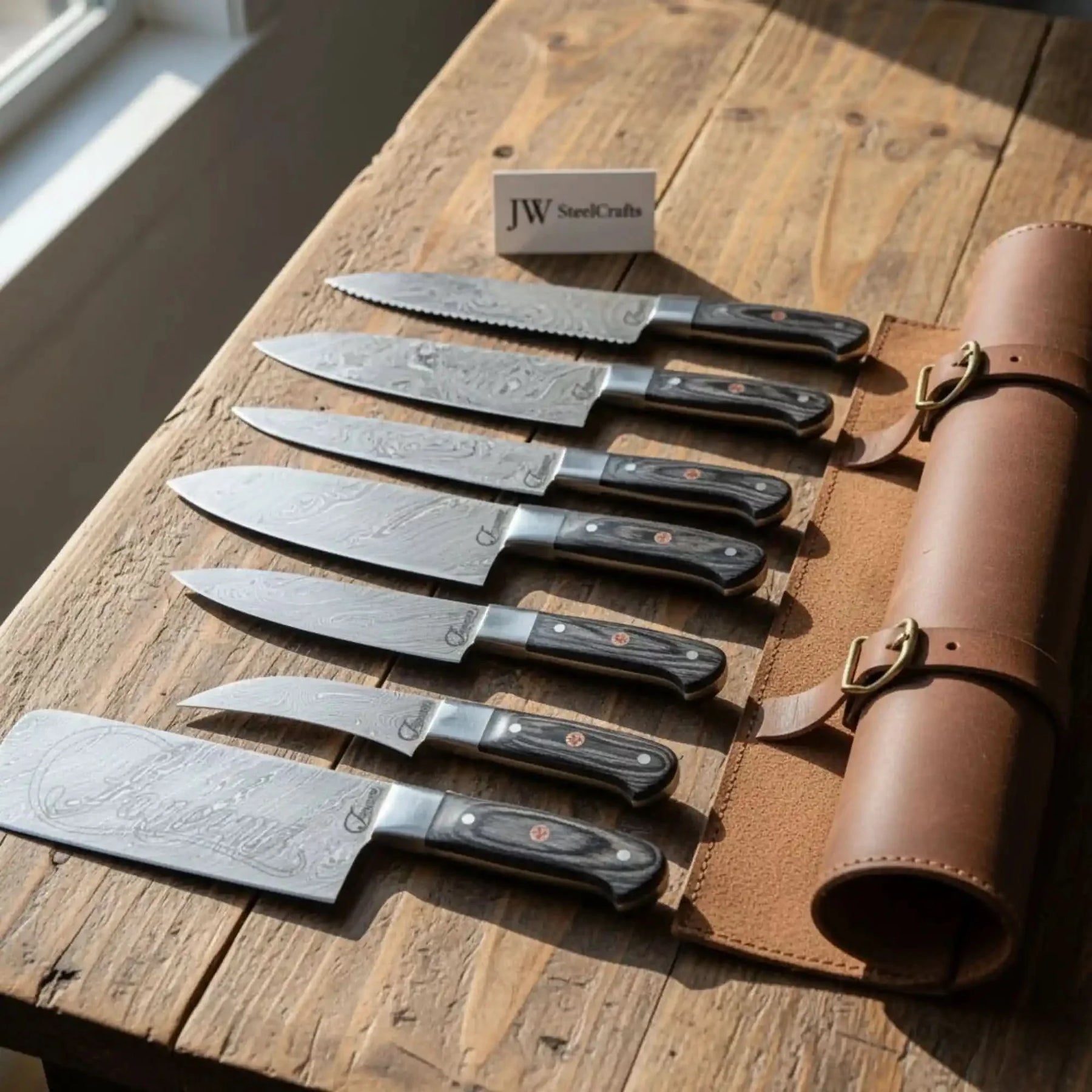 Handmade damascus steel knife with wood handle on dark surface