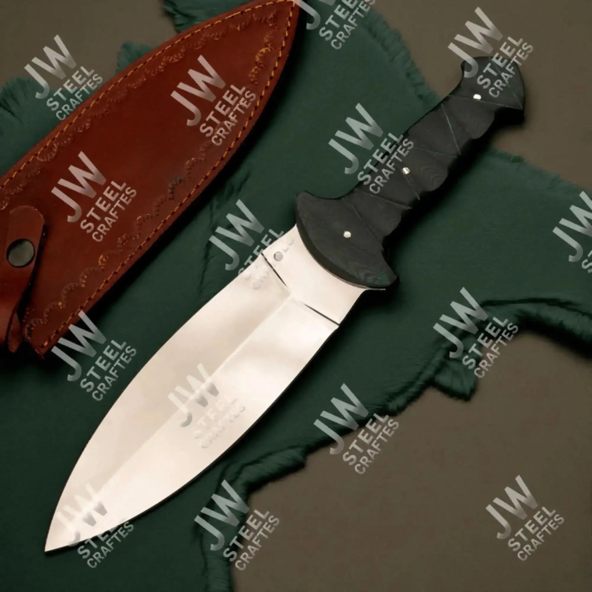 Handmade stainless steel steel knife with micarta handle on dark surface