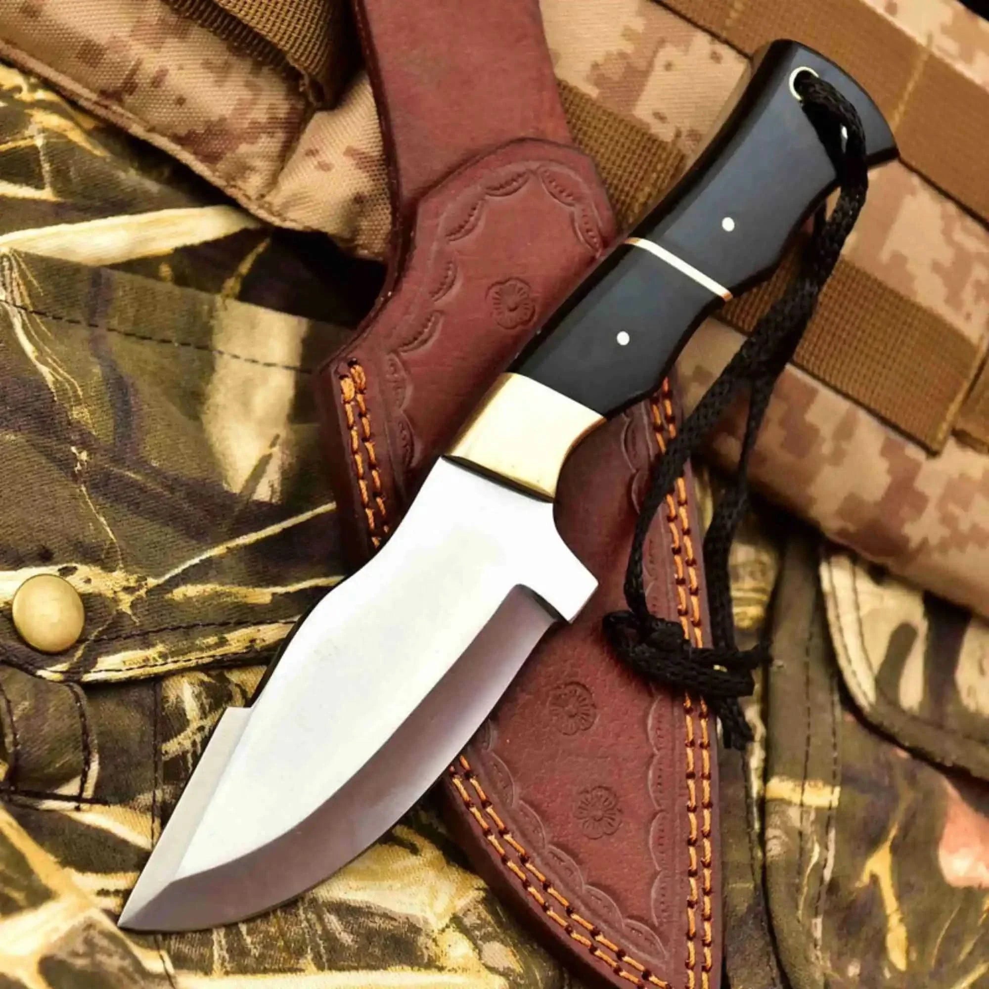 Handmade stainless steel steel knife with resin handle on dark surface