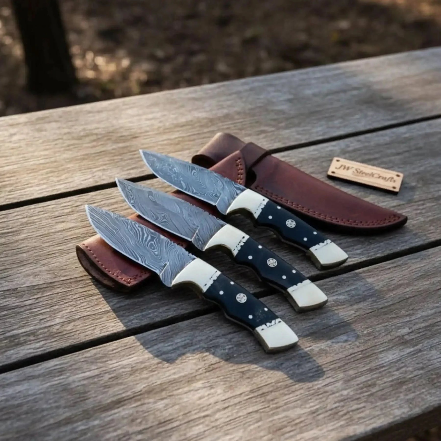 Handmade damascus steel knife with micarta handle on dark surface
