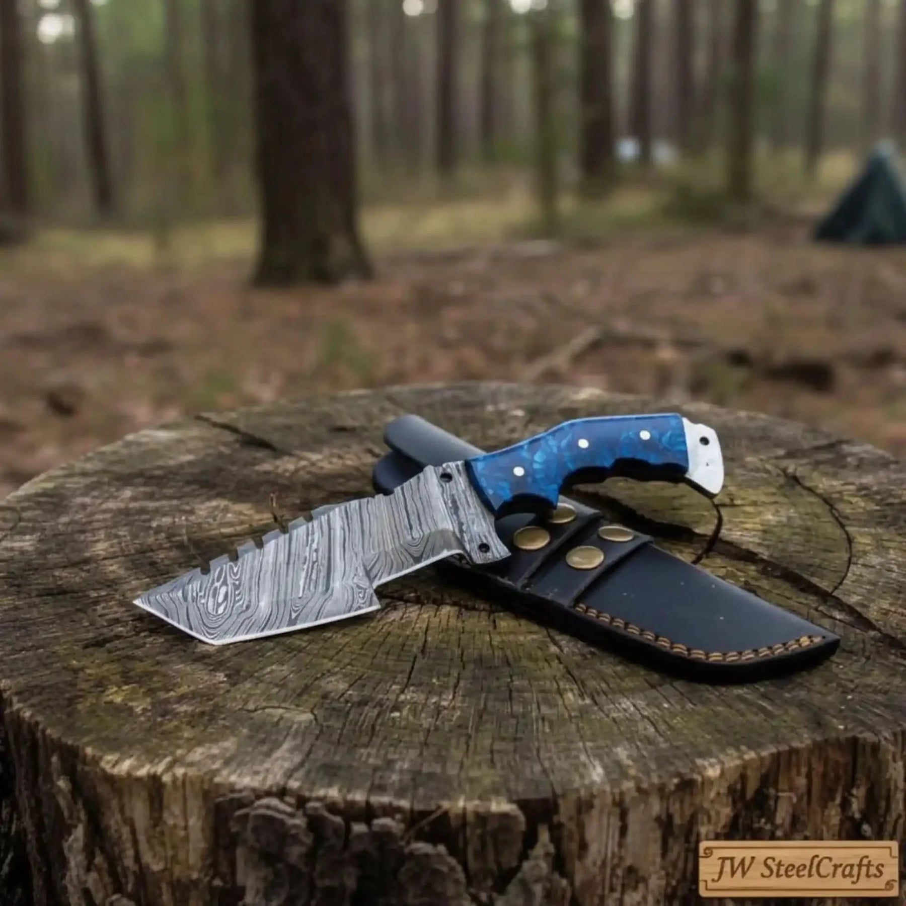 Handmade damascus steel knife with premium handle on dark surface