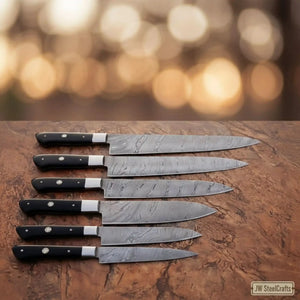 Handmade damascus steel knife with resin handle on dark surface