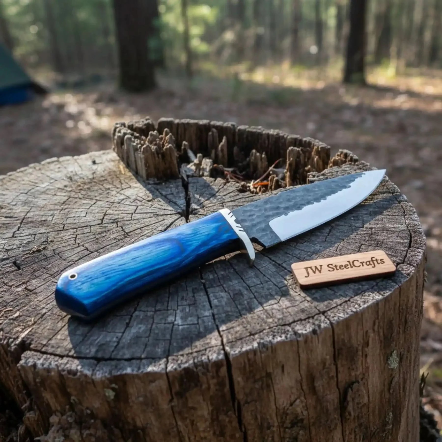 Handmade damascus steel knife with wood handle on dark surface