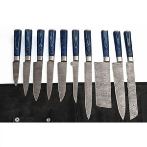 Handmade damascus steel knife with wood handle on dark surface