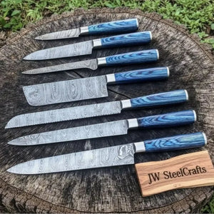 Handmade damascus steel knife with wood handle on dark surface