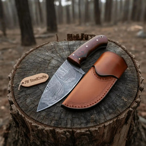 Handmade damascus steel knife with wood handle on dark surface