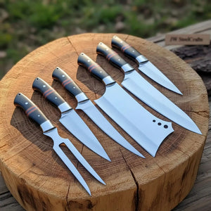 Handmade damascus steel knife with wood handle on dark surface