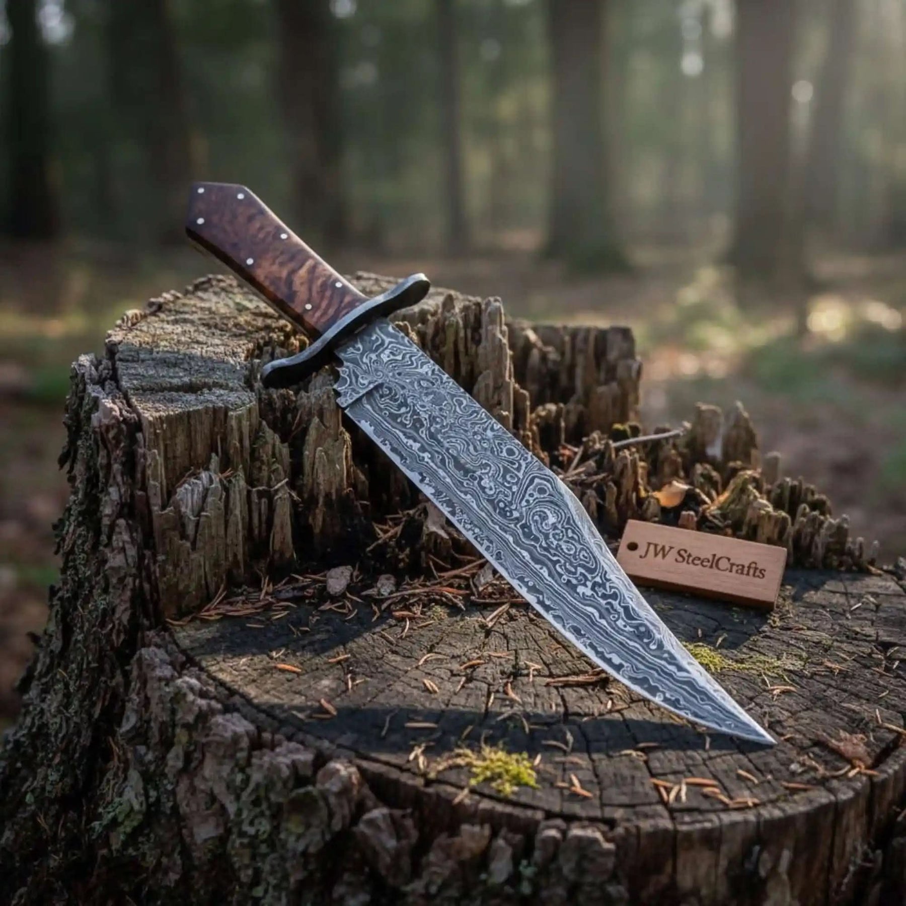 Handmade damascus steel knife with walnut handle on dark surface