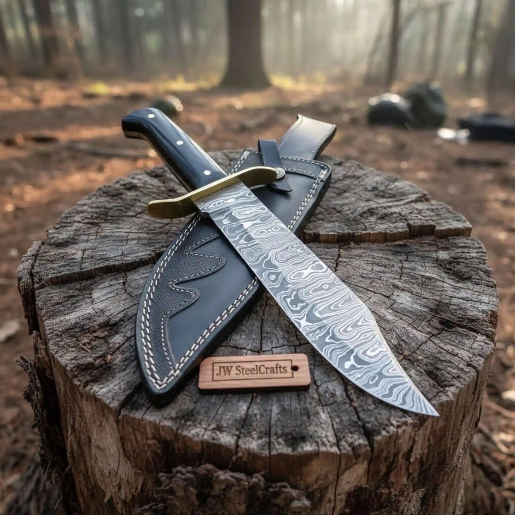 Handmade damascus steel knife with premium handle on dark surface