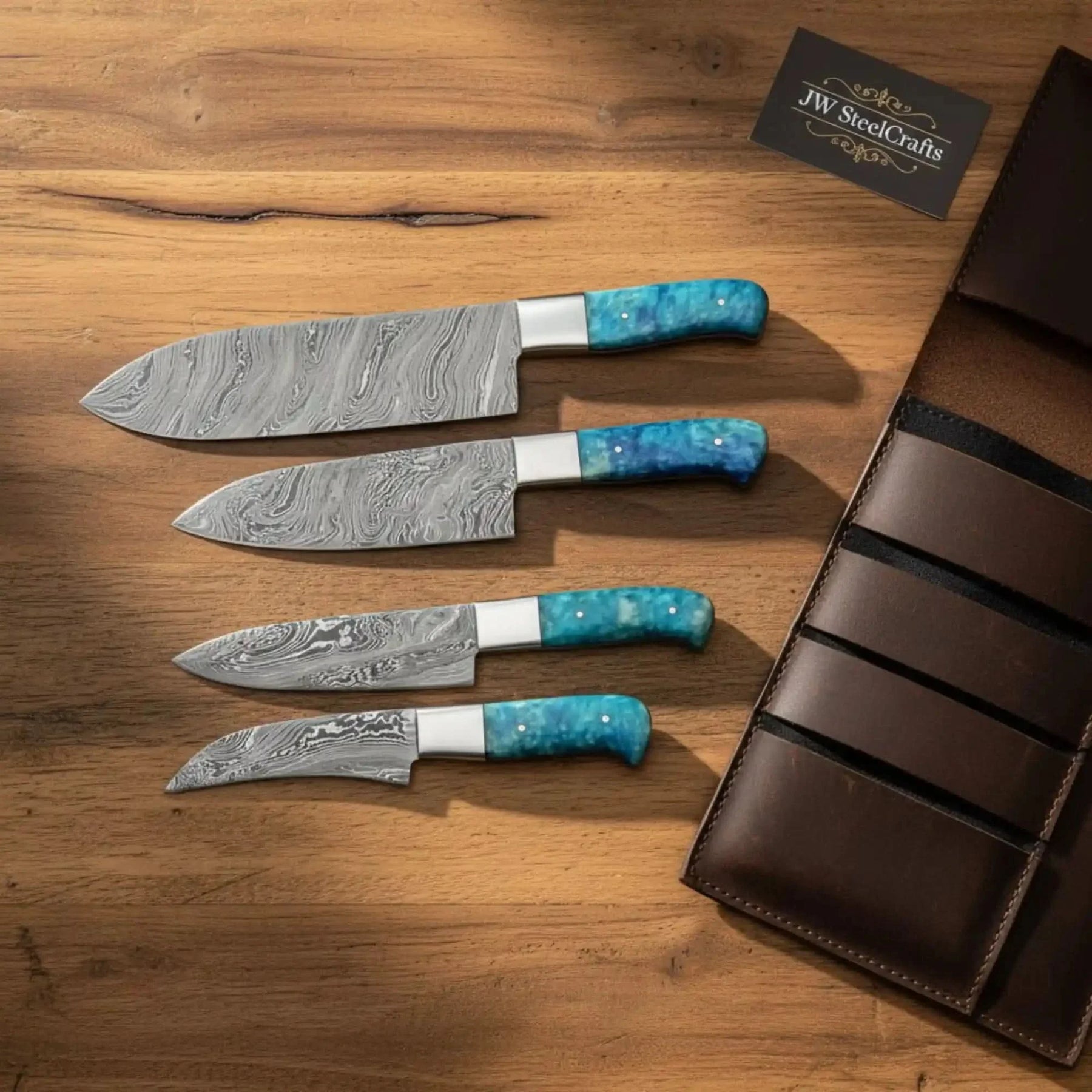 Handmade damascus steel knife with resin handle on dark surface