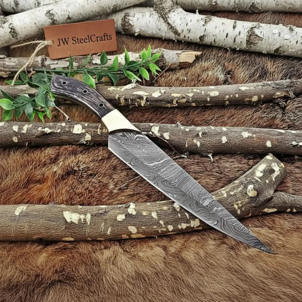 Handmade damascus steel knife with wood handle on dark surface