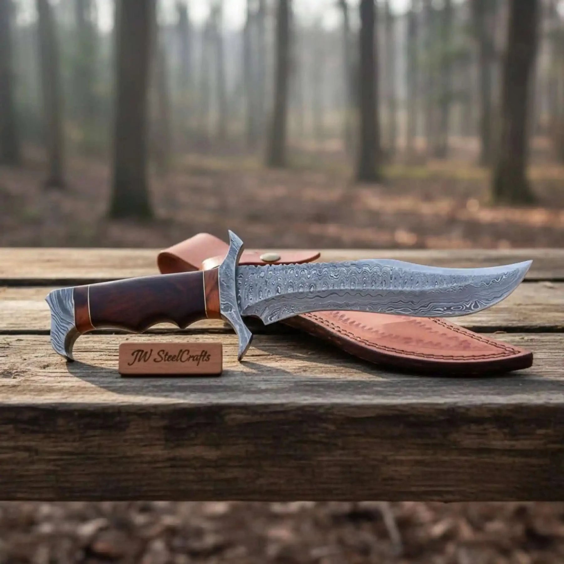 Handmade damascus steel knife with premium handle on dark surface