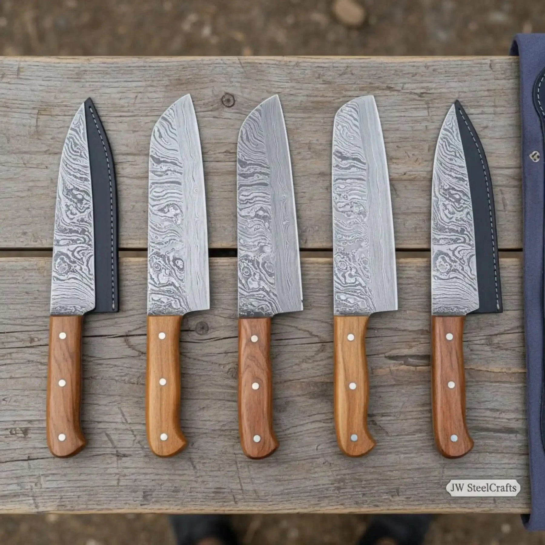 Handmade damascus steel knife with wood handle on dark surface