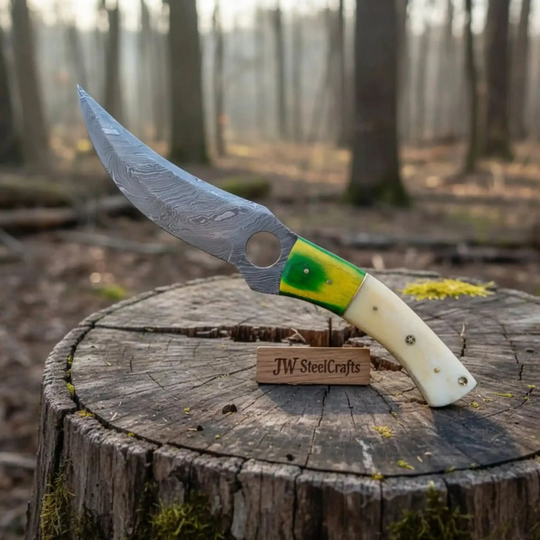 Handmade damascus steel knife with premium handle on dark surface