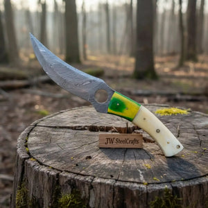 Handmade damascus steel knife with premium handle on dark surface