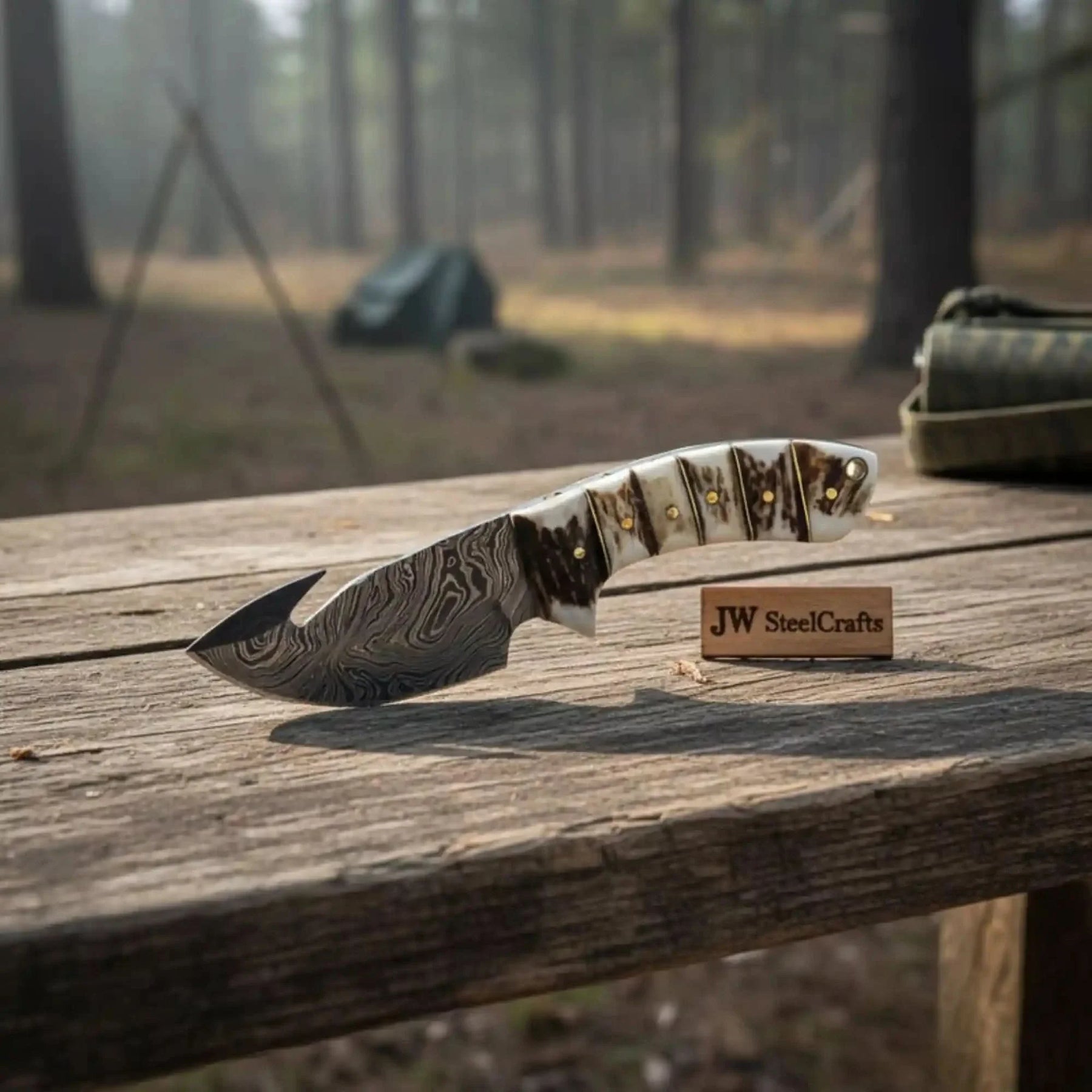 Handmade damascus steel knife with premium handle on dark surface