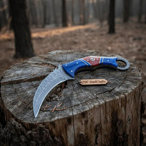 Handmade damascus steel knife with wood handle on dark surface