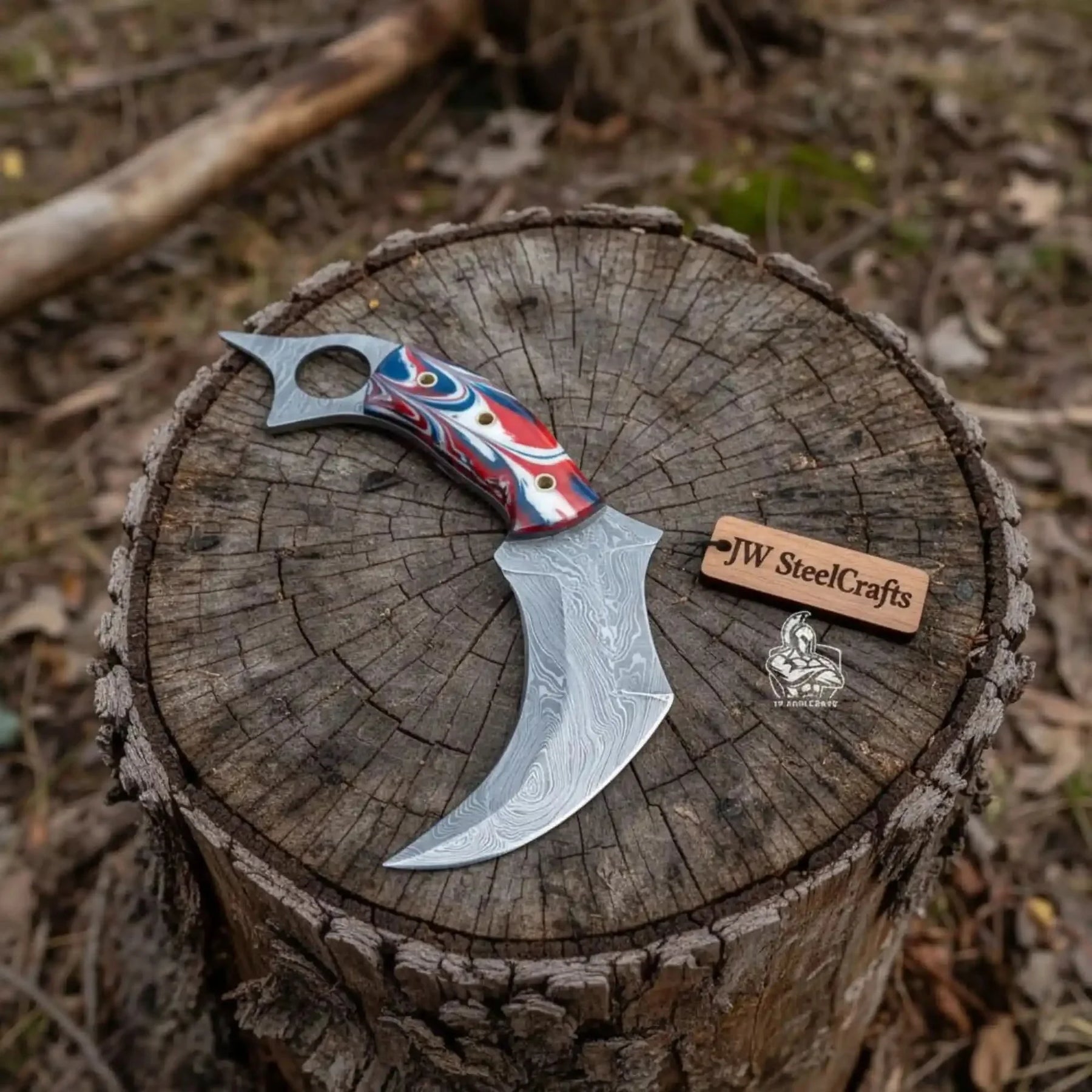Handmade damascus steel knife with premium handle on dark surface