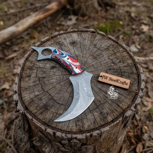 Handmade damascus steel knife with premium handle on dark surface