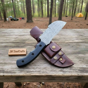 Handmade damascus steel knife with premium handle on dark surface
