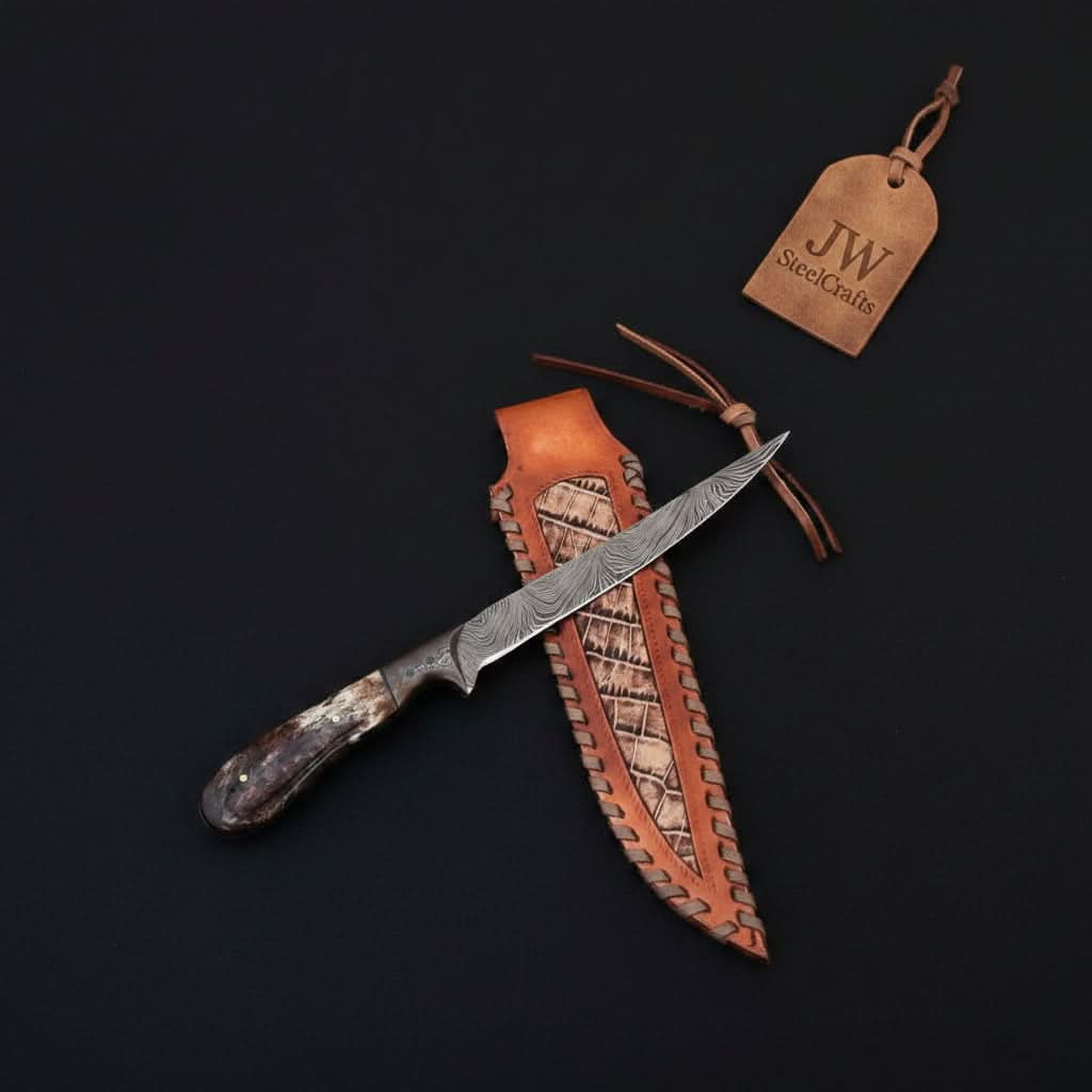 Handmade damascus steel knife with bone handle on dark surface