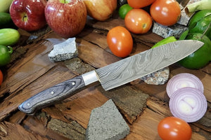 Handmade damascus steel knife with premium handle on dark surface