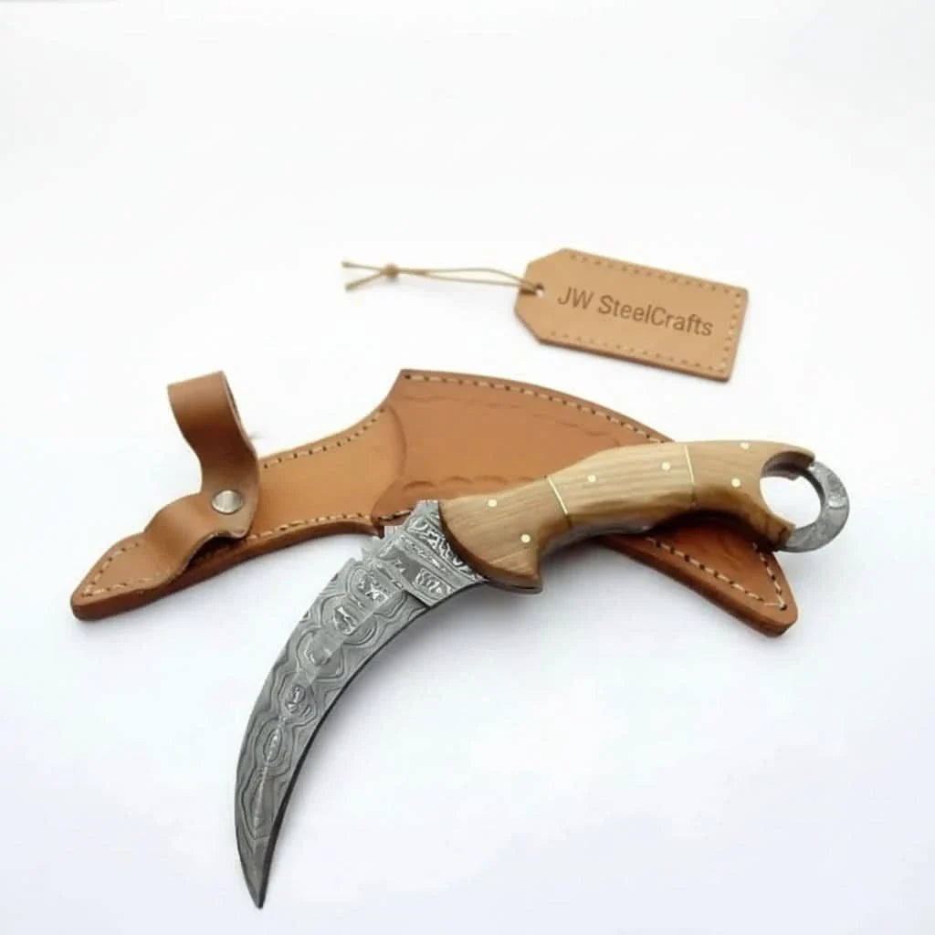Handmade damascus steel knife with premium handle on dark surface
