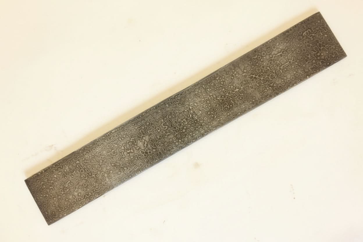 Handmade damascus steel knife with premium handle on dark surface