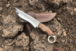 Handmade stainless steel steel knife with leather handle on dark surface