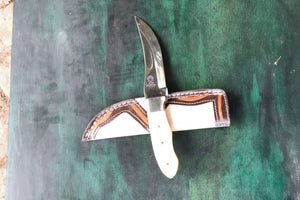 Handmade stainless steel steel knife with premium handle on dark surface