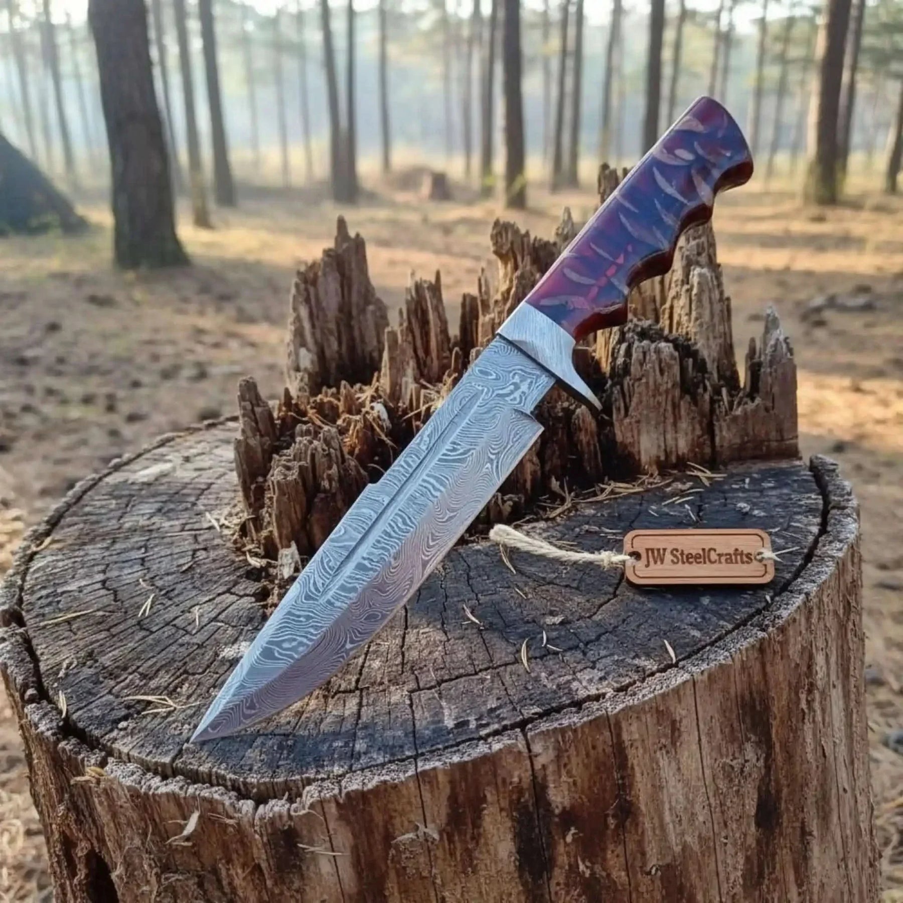 Handmade damascus steel knife with premium handle on dark surface