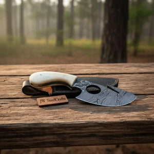 Handmade damascus steel knife with premium handle on dark surface