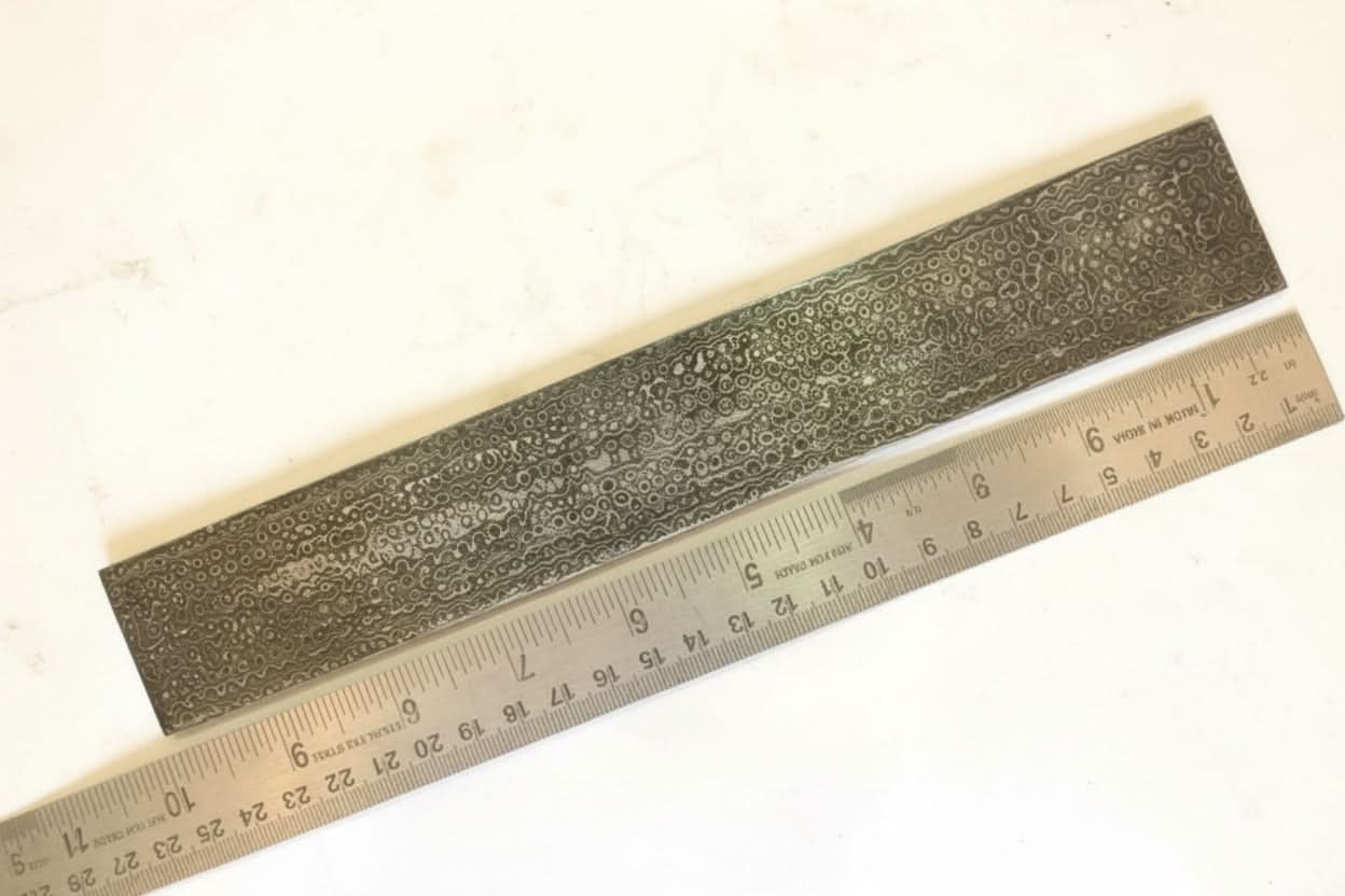 Handmade damascus steel knife with premium handle on dark surface