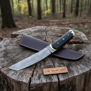 Handmade damascus steel knife with premium handle on dark surface