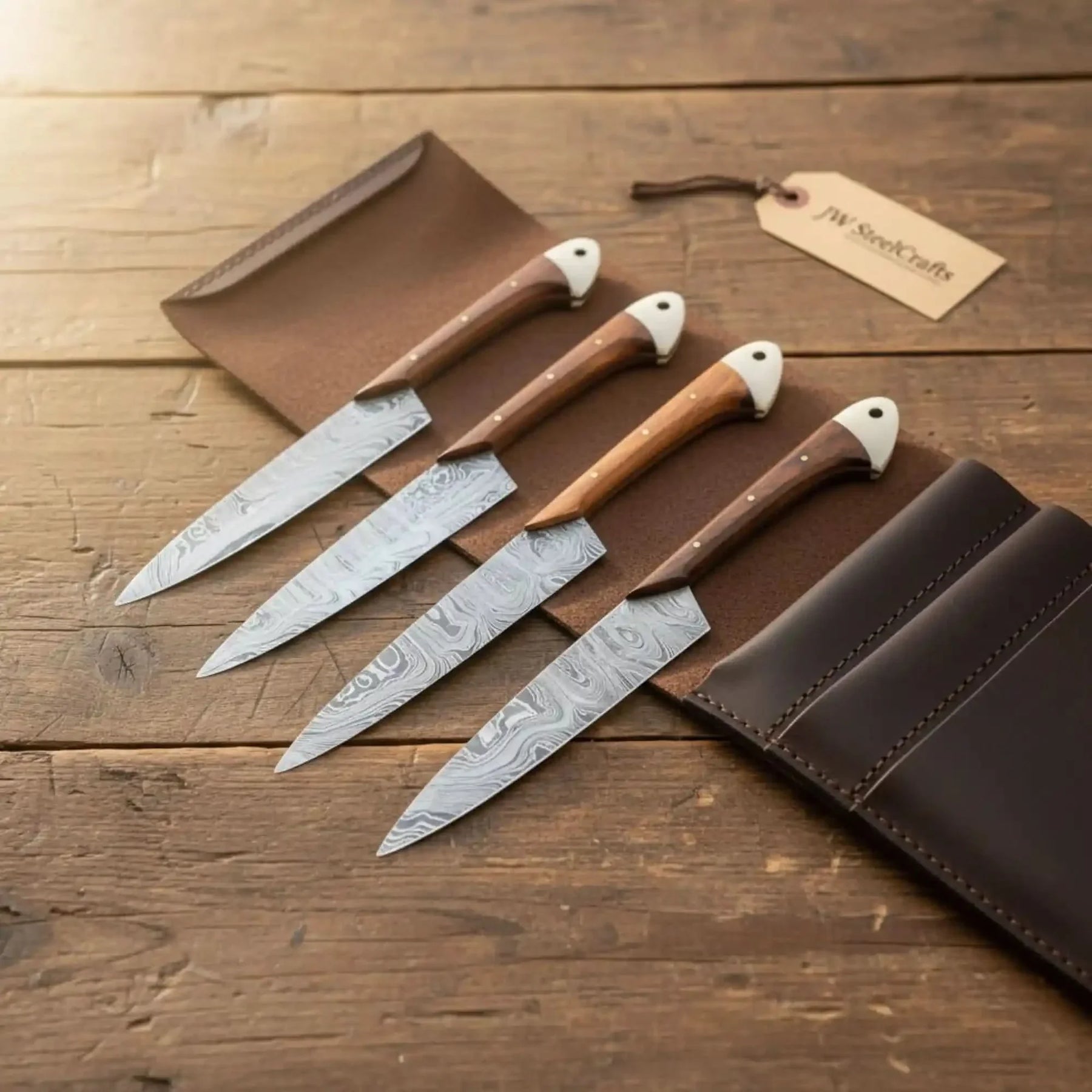 Handmade damascus steel knife with wood handle on dark surface