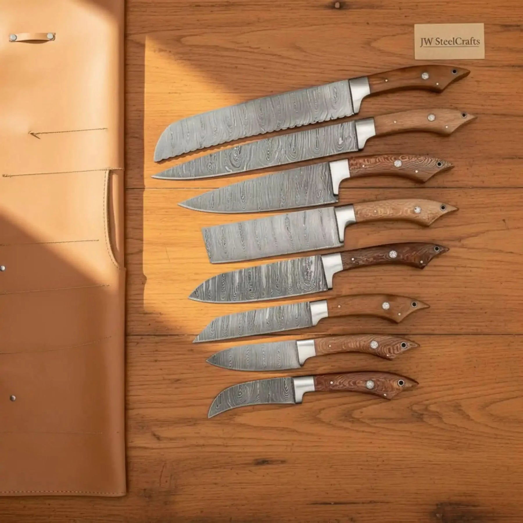 Handmade damascus steel knife with wood handle on dark surface
