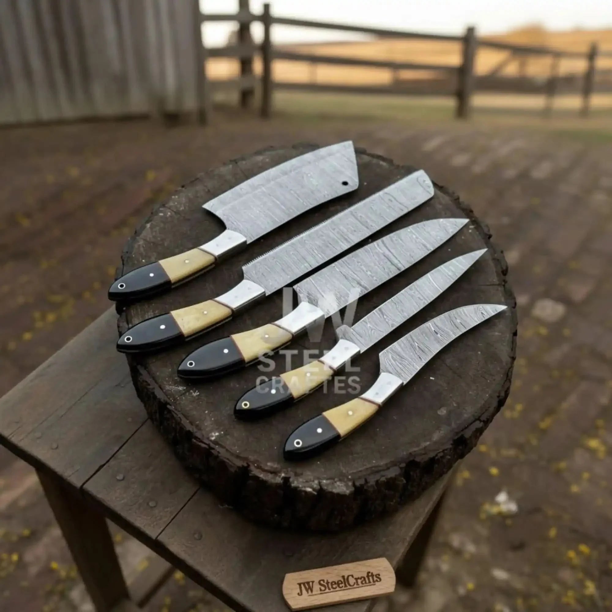 Handmade damascus steel knife with bone handle on dark surface
