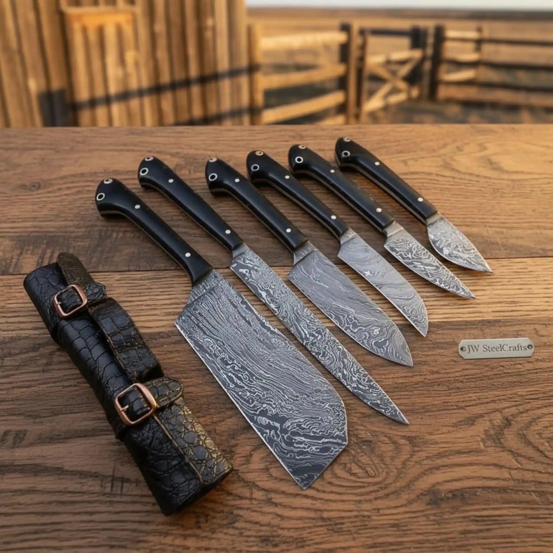 Handmade damascus steel knife with leather handle on dark surface