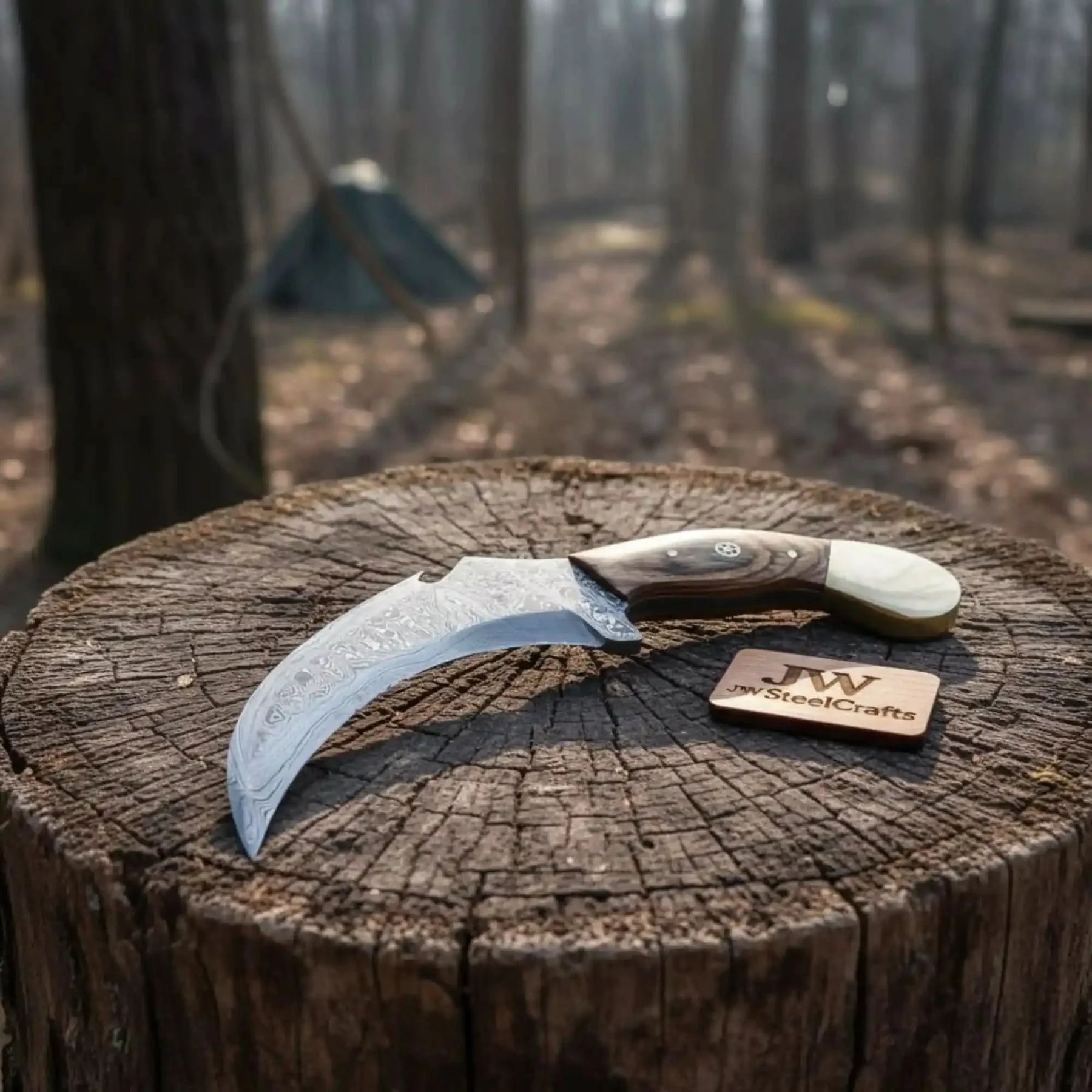 Handmade damascus steel knife with premium handle on dark surface